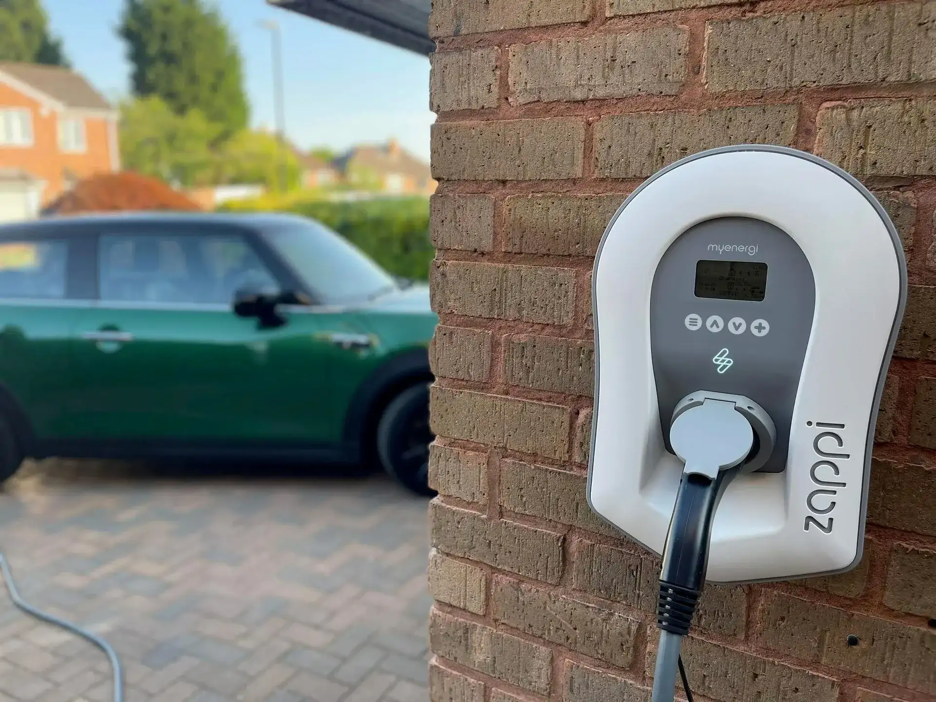 White myenergi Zappi EV charger professionally mounted on an exterior wall