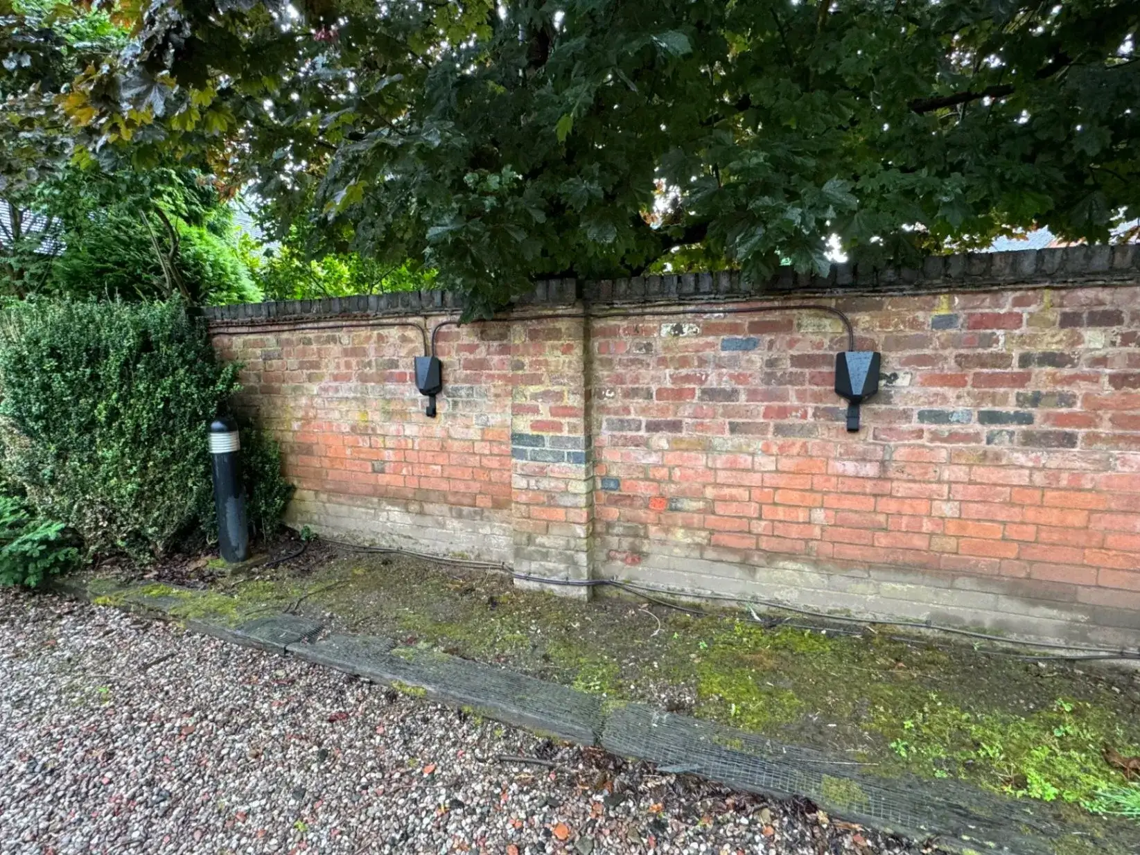 Two EV chargers installed side by side on an exterior residential wall