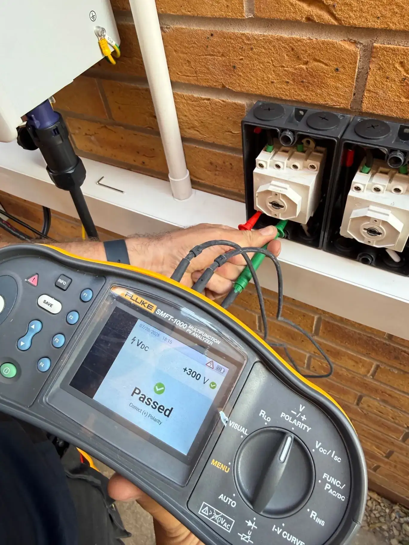 Electrician testing a solar and electrical installation with a Fluke tester