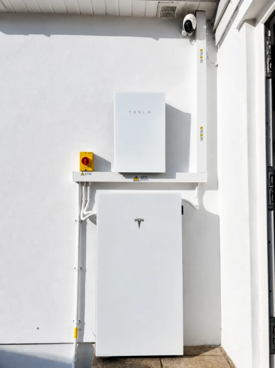 Tesla Powerwall 3 and Gateway 2 mounted together on an interior wall